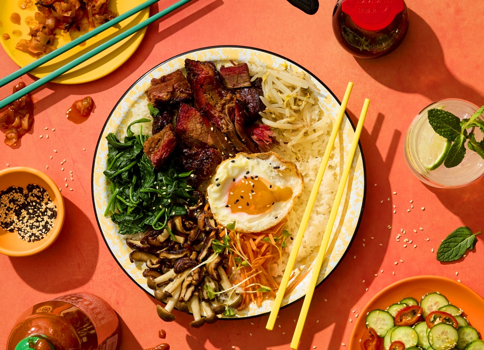 austin blues beef brisket ramen bowl topped with a fried egg, viewed on a table with other food and drink